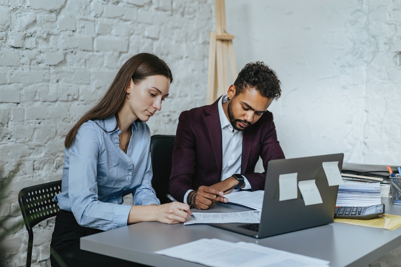 A-man-and-a-woman-sitting-at-a-table-while-working