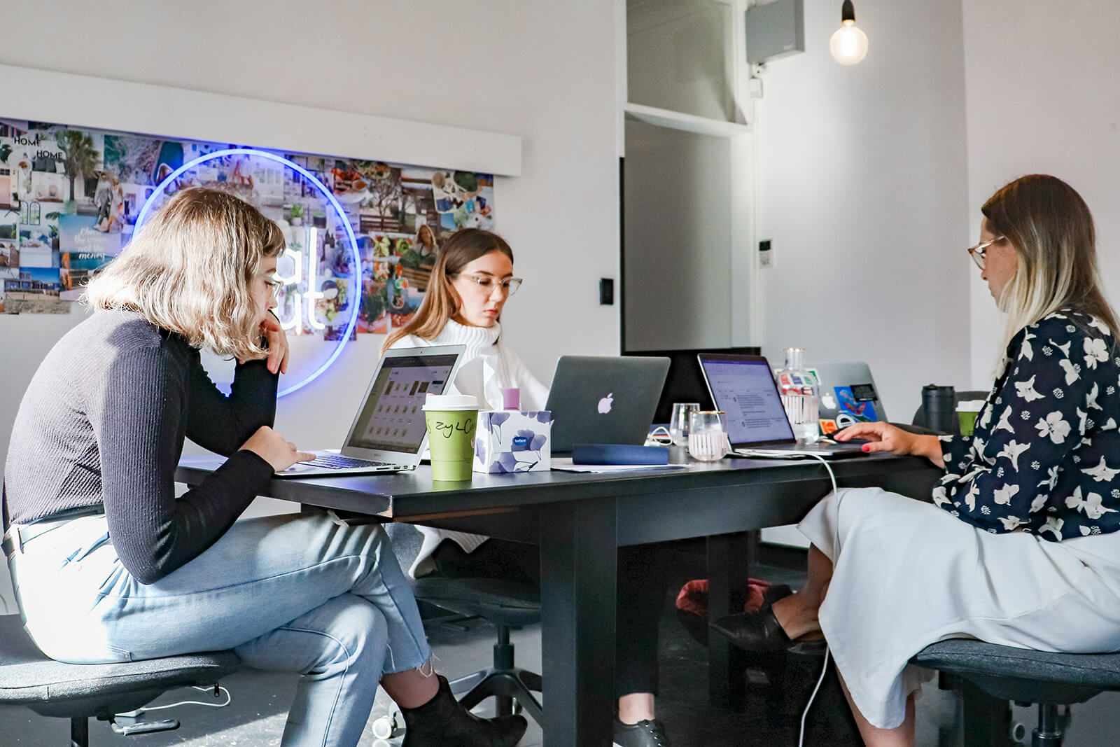 Team of employees sitting at desk on computers