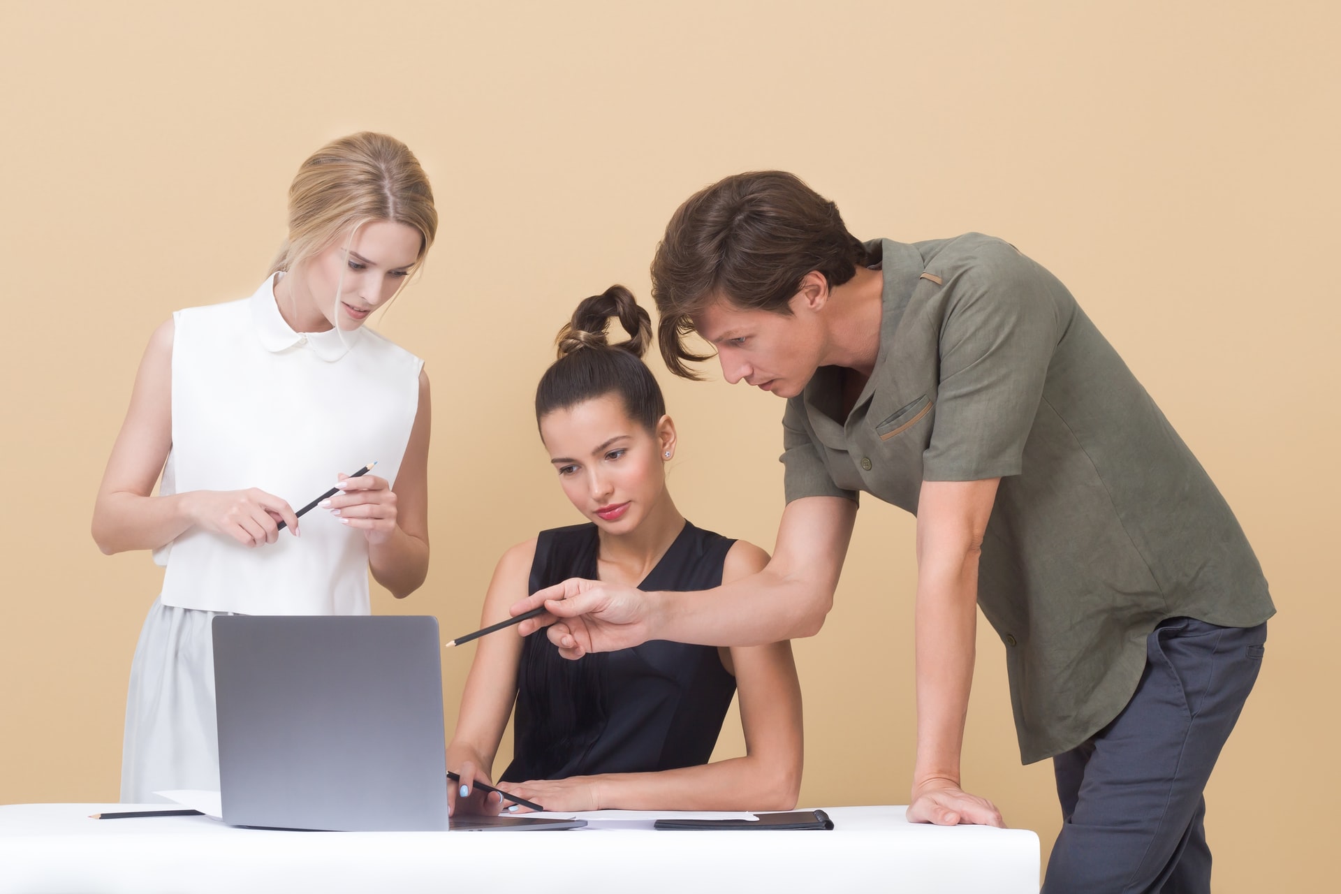 Communications team drafting employee email newsletter at laptop