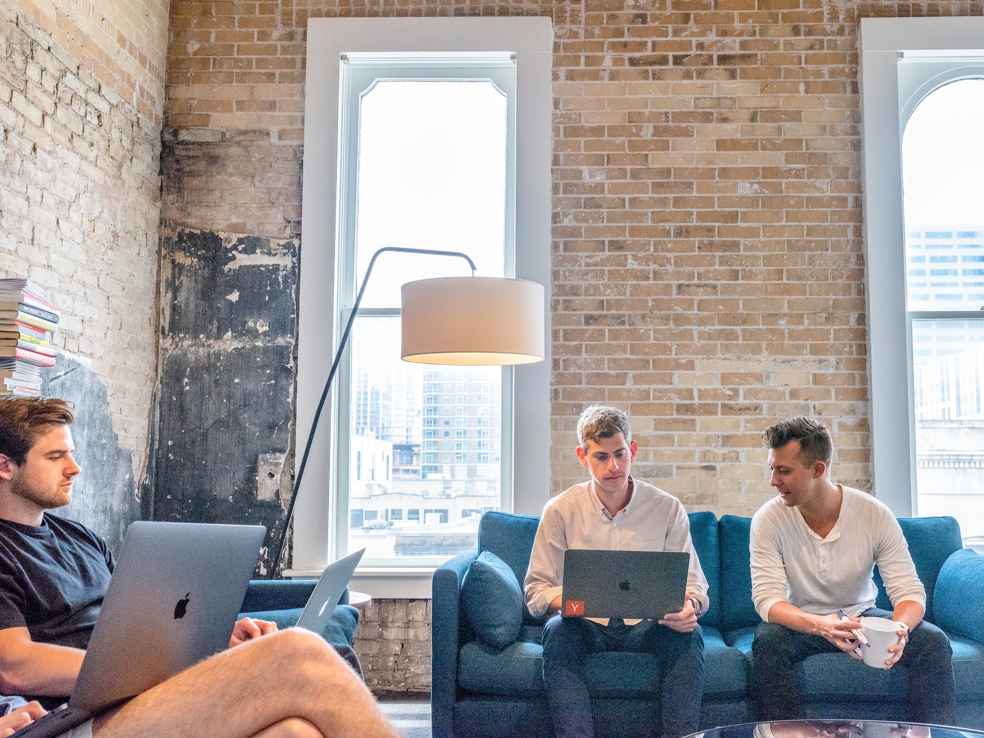 Employees working together on laptops in shared working space