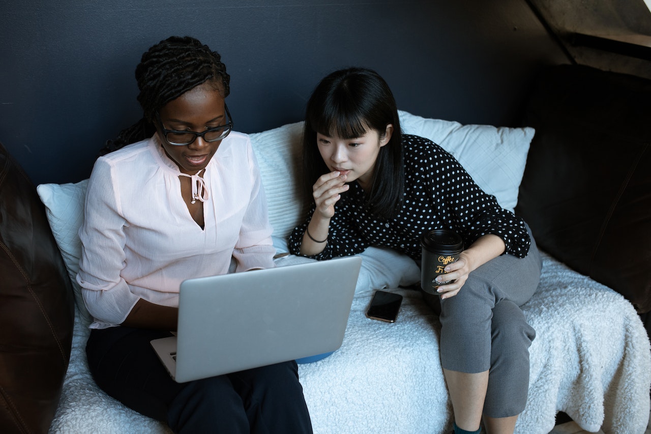 HR professionals reading emails on laptop