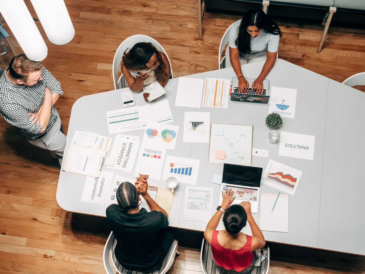 Overhead shot of a group of colleagues discussing and planning their marketing strategy