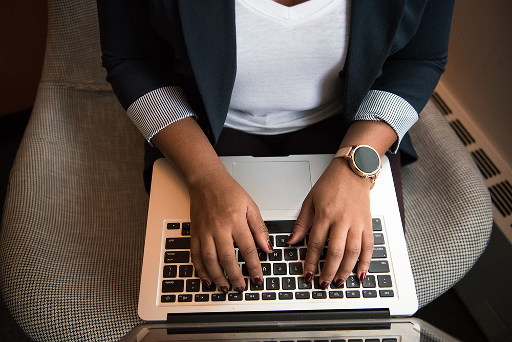 Person in office chair working on a laptop