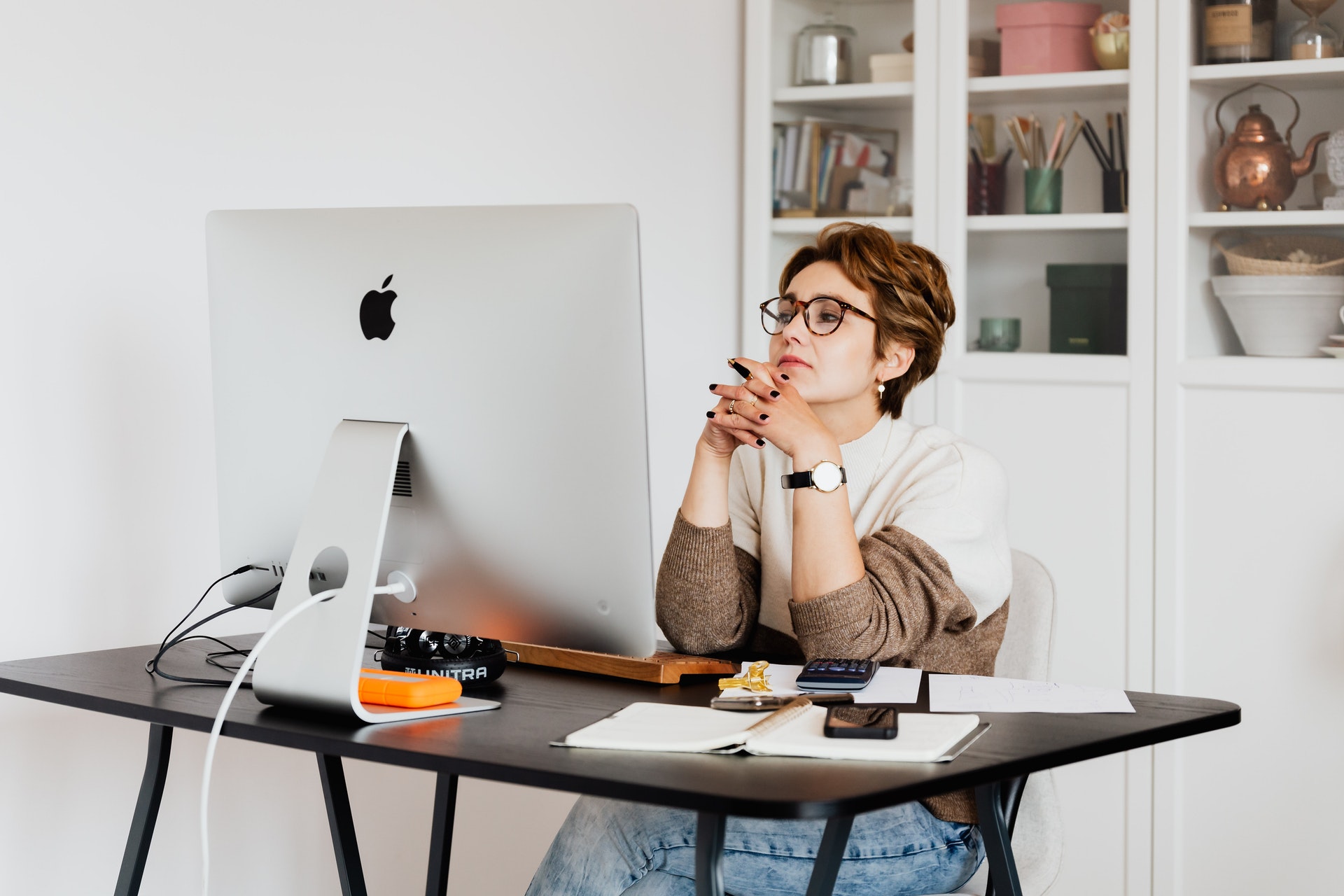 Woman in front of a computer planning email newsletter