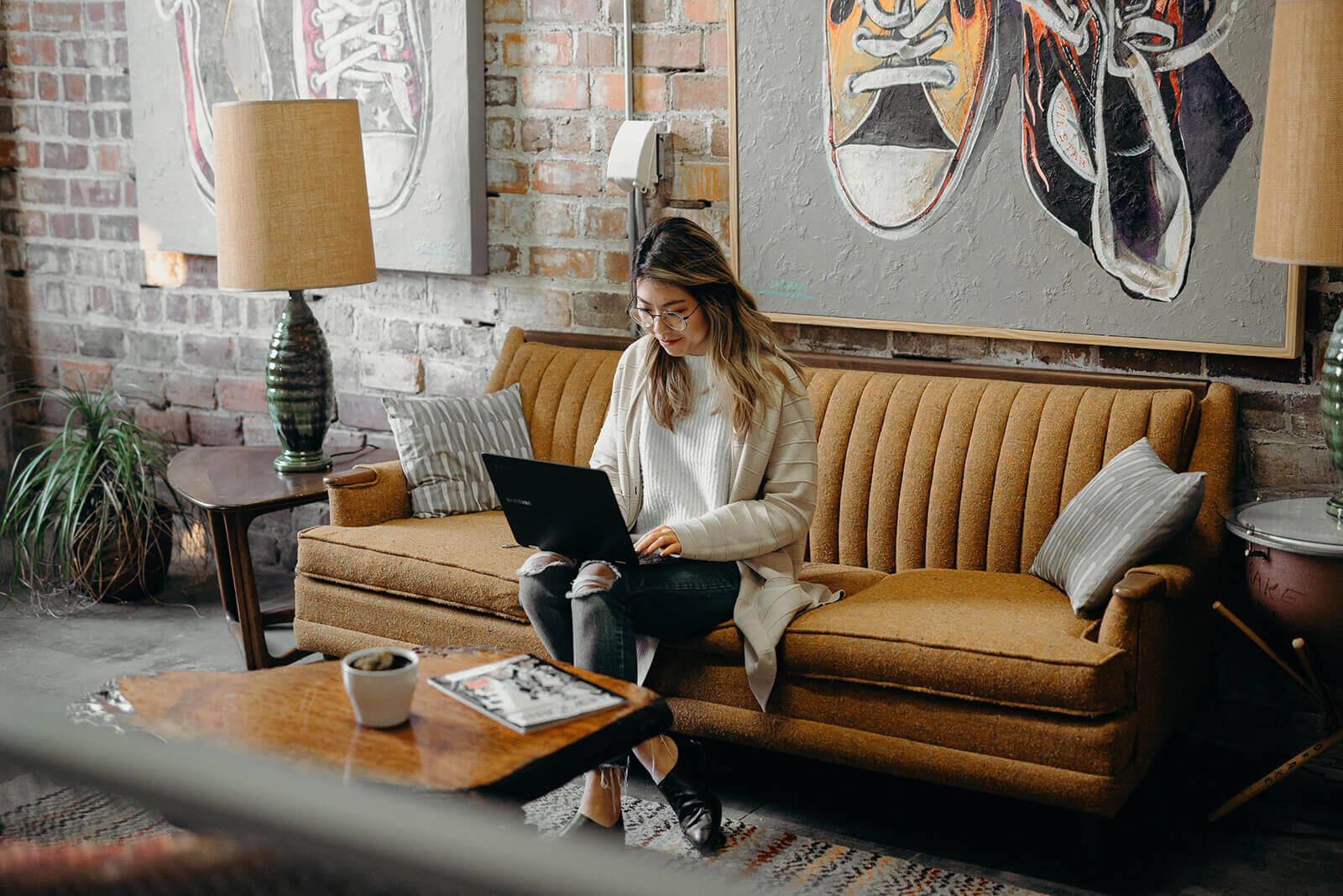 Employee sitting on couch with a laptop