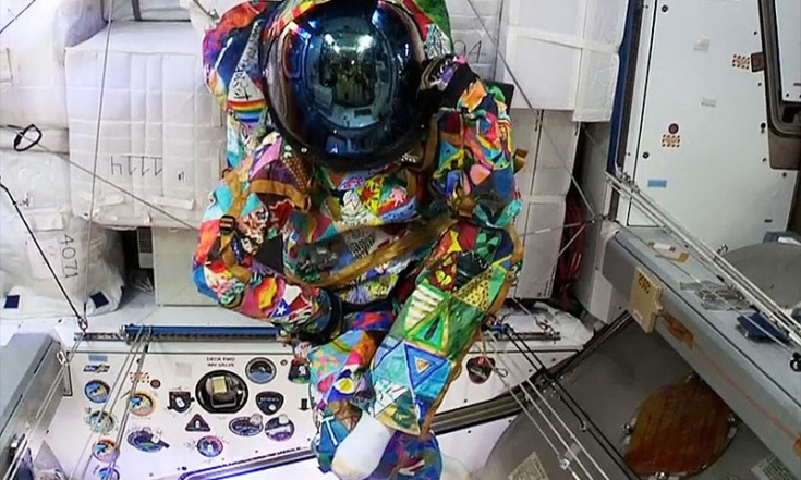 Colorful spacesuit painted by children with cancer worn by...